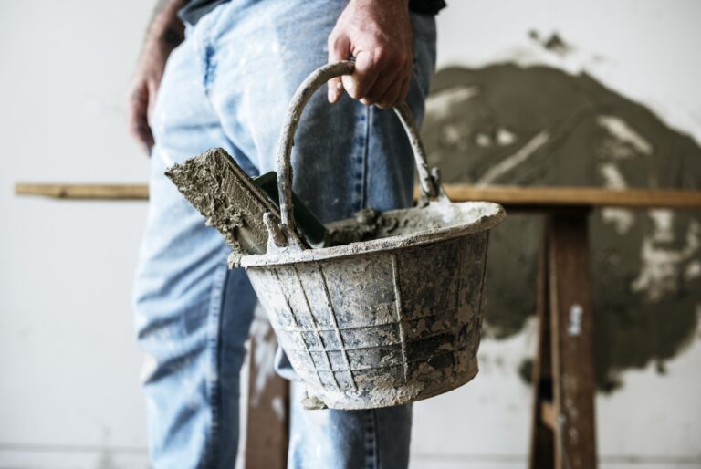 Handyman holding basket cement for construction